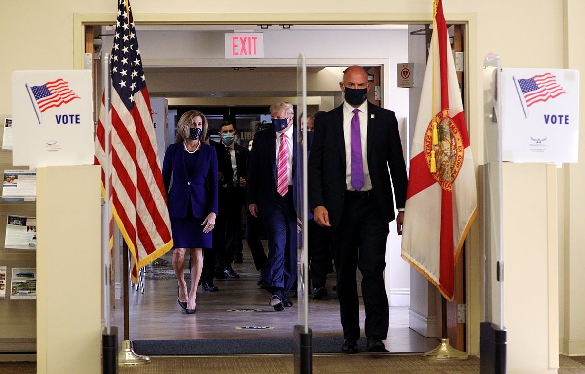 US president Donald Trump wearing a face mask leaves after voting in the 2020 presidential election at the Palm Beach County Library in West Palm Beach, US, on 24 October 2020