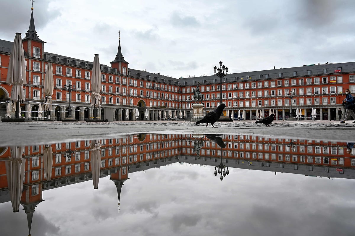 In this AFP photo taken on 21 April 2020 a lone person crosses the deserted Plaza Mayor square in Madrid amid a national lockdown to fight the spread of the novel coronavirus. Spain surpassed one million virus cases on 21 October 2020 according to health ministry figures