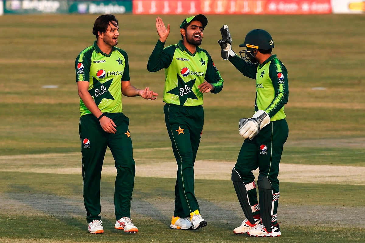 Pakistan's captain Babar Azam (C) celebrates with teammates after the dismissal of Zimbabwe's captain Chamu Chibhabha (not pictured) during the third Twenty20 cricket match between Pakistan and Zimbabwe at the Rawalpindi Cricket Stadium in Rawalpindi on 10 November 2020