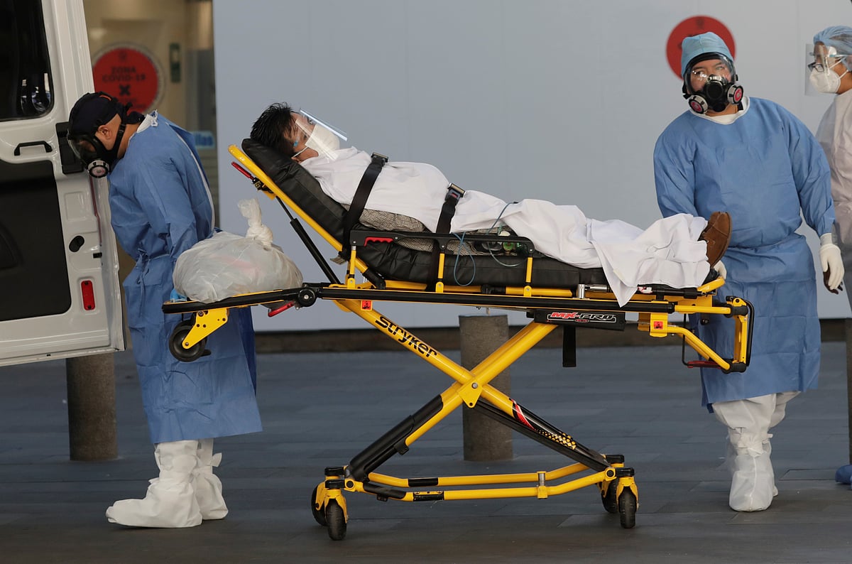 Ambulance attendants transport a patient with suspected symptoms of a coronavirus disease (COVID-19) infection to an ambulance to be transferred to another hospital, as the outbreak continues, in Mexico City, Mexico, on 13 November 2020