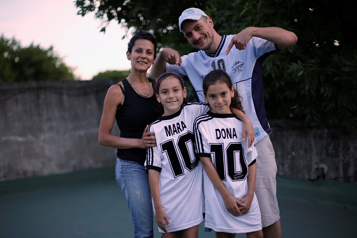 Walter Gaston Rotundo, a devoted Diego Maradona fan who named his twin daughters Mara and Dona after the soccer star, poses with his family in Buenos Aires, Argentina, 27 November, 2020.
