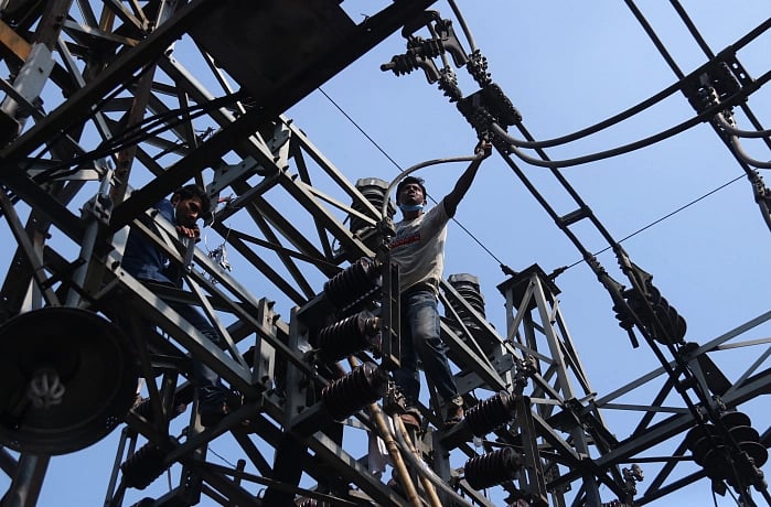 Power department workers work to restore electricity in Sylhet on 19 November after fire broke out a Kumargaon grid