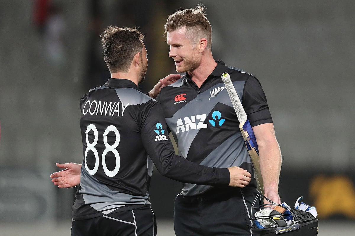 New Zealand’s James Neesham (R) and Devon Conway (L) celebrate their victory during the Twenty20 international cricket match between New Zealand and the West Indies at Eden Park in Auckland on 27 November, 2020.
