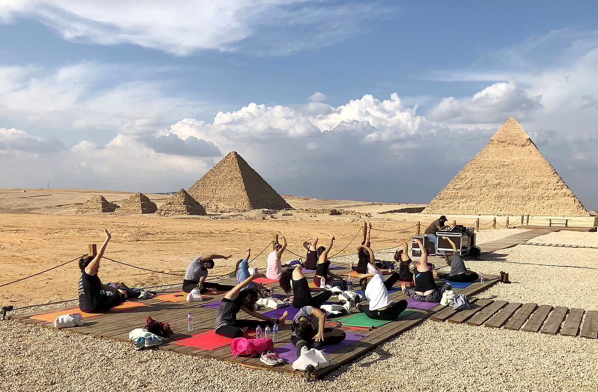 Women attend a Yes Yoga Day event in support of the eradication of violence against women amid the coronavirus disease (COVID-19) in front of the historical Giza pyramids, Egypt