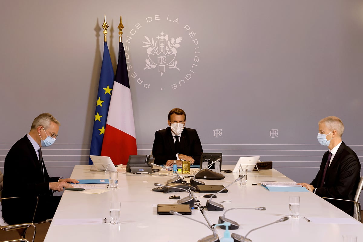French president Emmanuel Macron, flanked by French Minister of the Economy, Finance, and Recovery Bruno Le Maire and French Junior Minister of Foreign Trade Franck Riester, chairs a video conference with foreign companies' executives to market France as Europe's next business destination after the coronavirus disease (COVID-19) crisis, at the Elysee presidential Palace in Paris, France on 6 November 2020