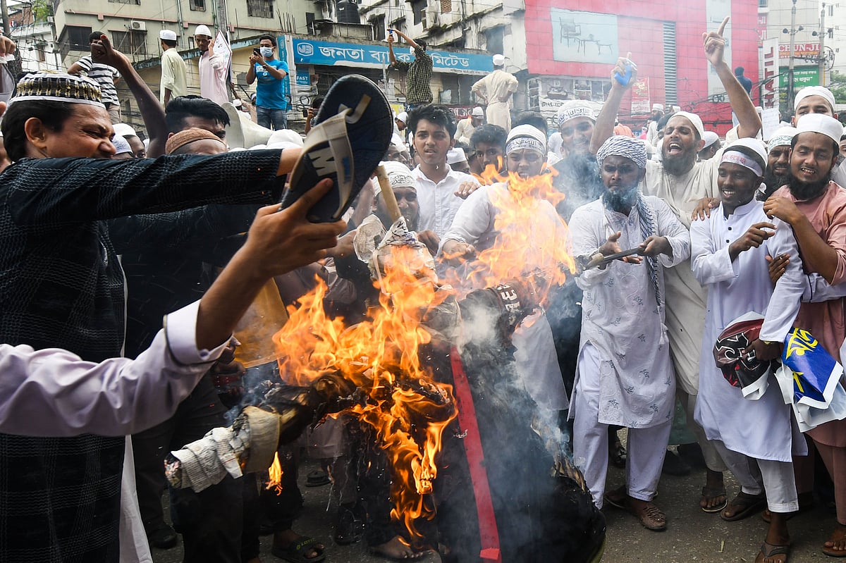 Protesters set an effigy of French president Emmanuel Macron on fire during an anti-France demonstration in Dhaka on 2 November 2020