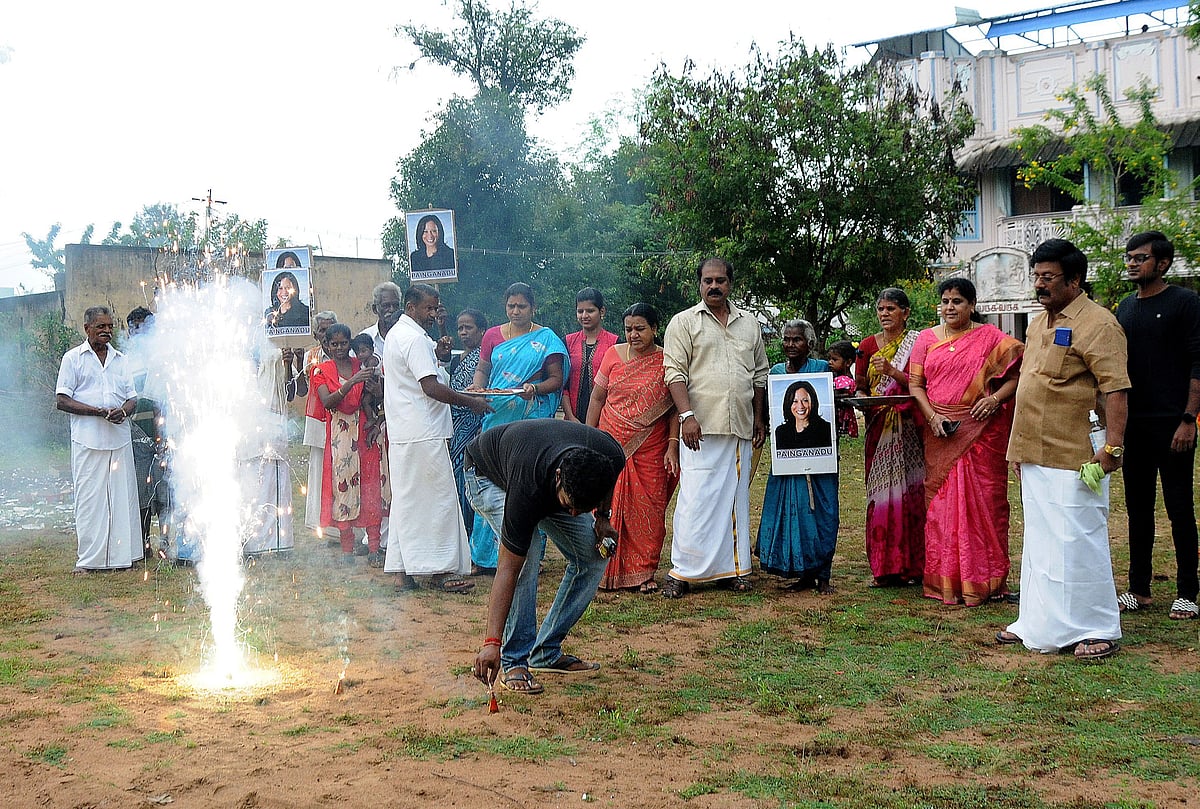 A man lights fireworks as villagers gather to celebrate the victory of US vice president-elect Kamala Harris in Painganadu near the village of Thulasendrapuram, where Harris' maternal grandfather was born and grew up, in the southern state of Tamil Nadu, India, 8 November, 2020.