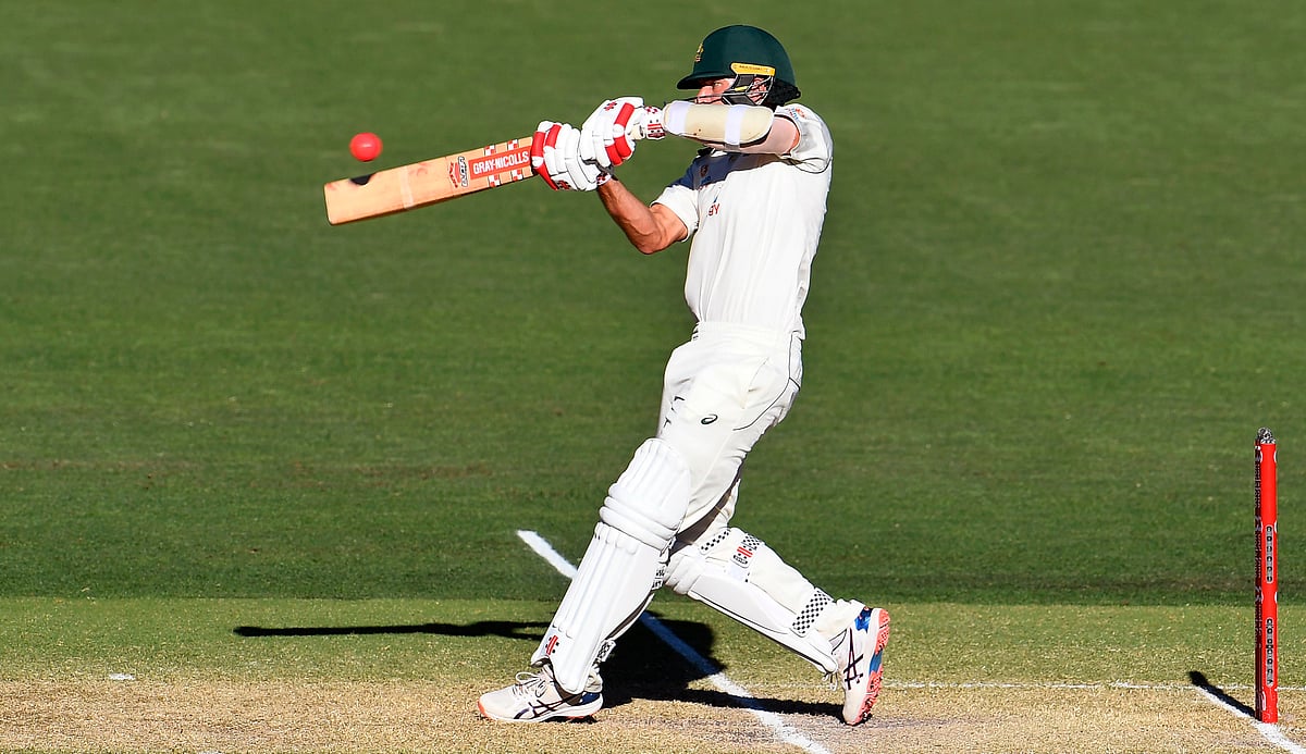Australia's Joe Burns hits a six to bring up his 50 and victory for Australia on the third day of the first cricket Test match between Australia and India played in Adelaide on 19 December 2020