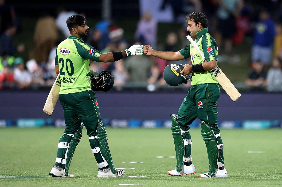 Pakistan's batsmen Hussain Talat (L) and Iftikhar Ahmed celebrate victory in the third T20 cricket match between New Zealand and Pakistan at McLean Park in Napier on 22 December 2020
