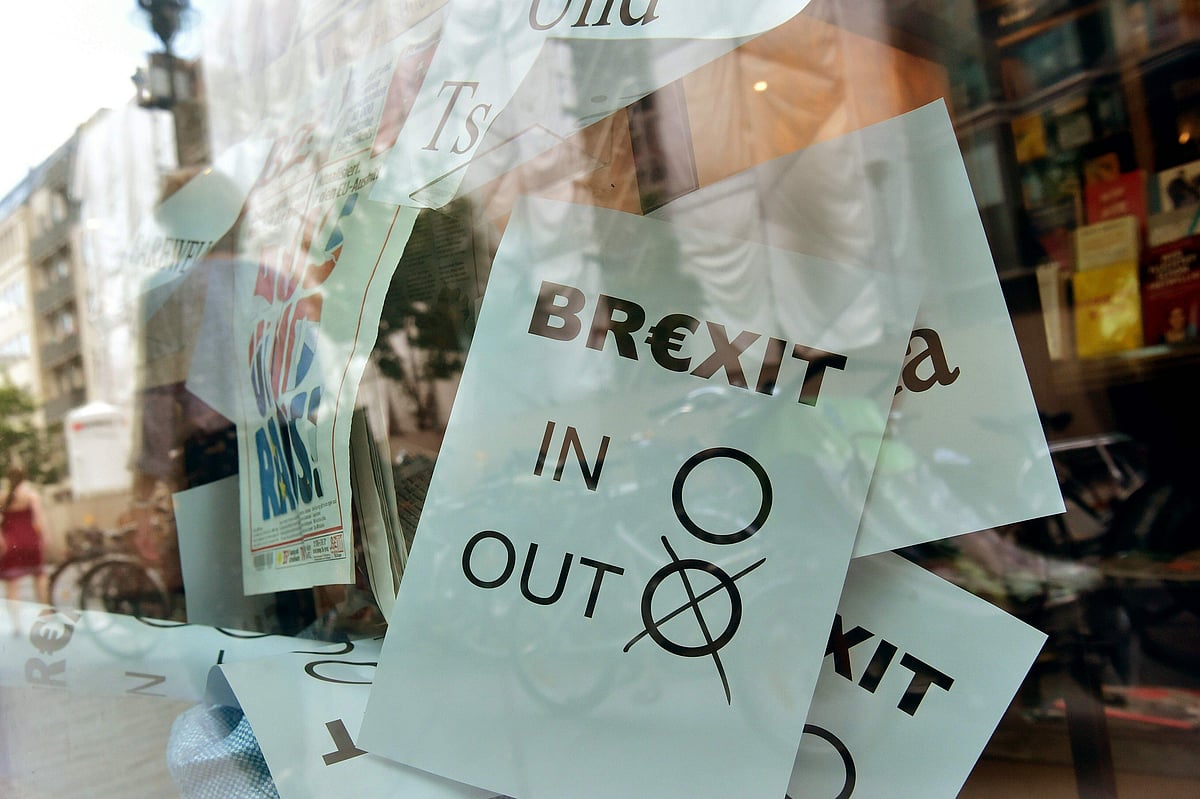 In this file photo taken on 24 June 2016 a poster featuring a Brexit vote ballot with "out" tagged is on display at a book shop window in Berlin