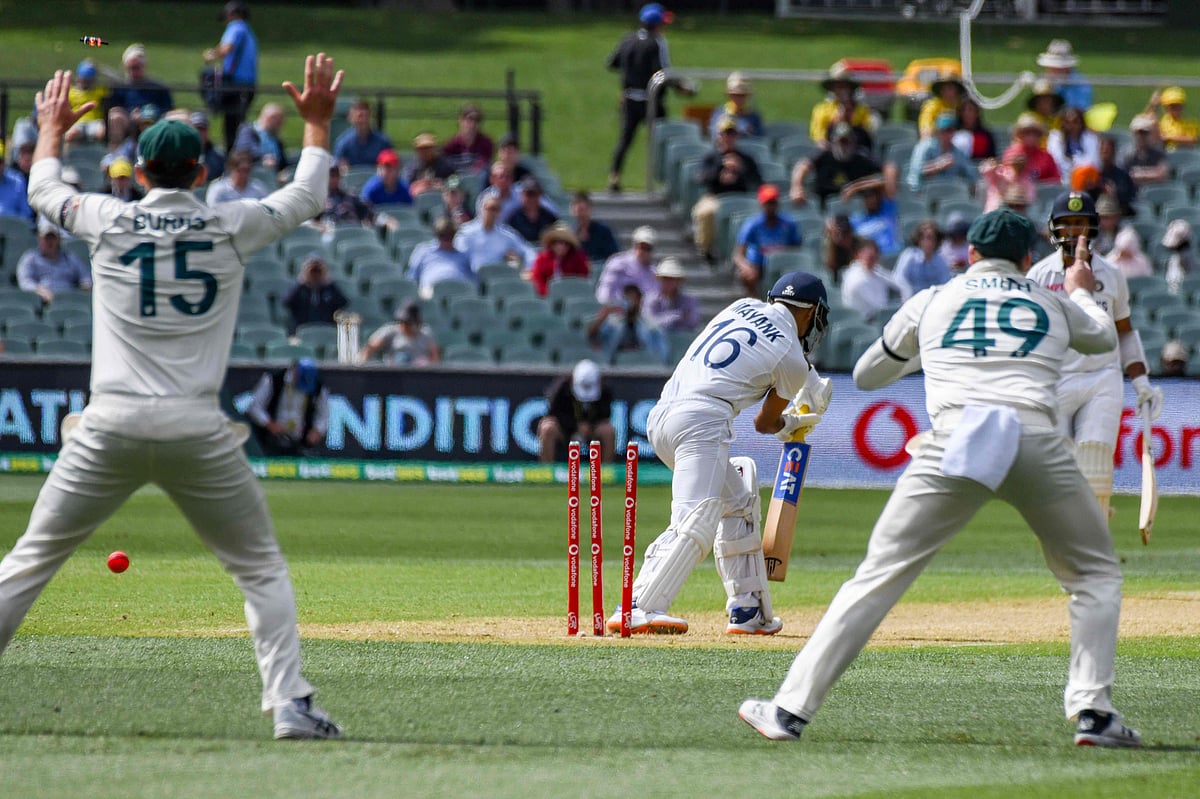 India's batsman Mayank Agarwal (C) is celan bowled by Australia's paceman Pat Cummins on day one of the First cricket Test match between Australia and India in Adelaide on 17 December 2020