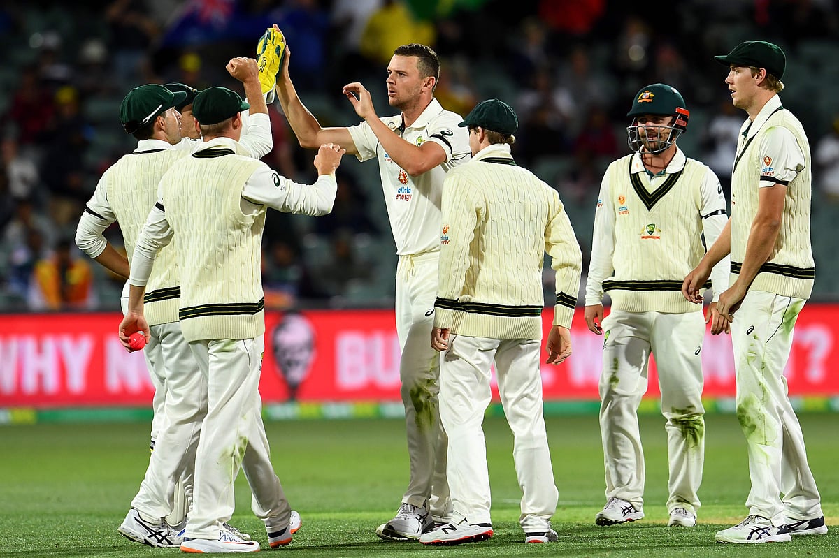 Australia's paceman Josh Hazlewood (C) celebrate his wicket of India's batsman Hanuma Vihari during the day one of the first cricket Test match between Australia and India in Adelaide on 17 December 2020