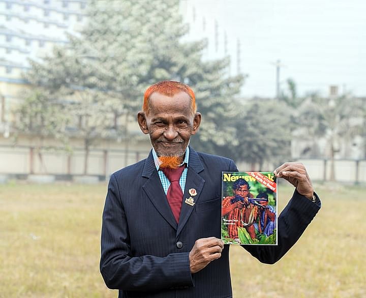 71-year-old Hebzul Bari holding up a copy of Newsweek published on 6 December 1971 within him, as a freedom fighter, featured on the cover