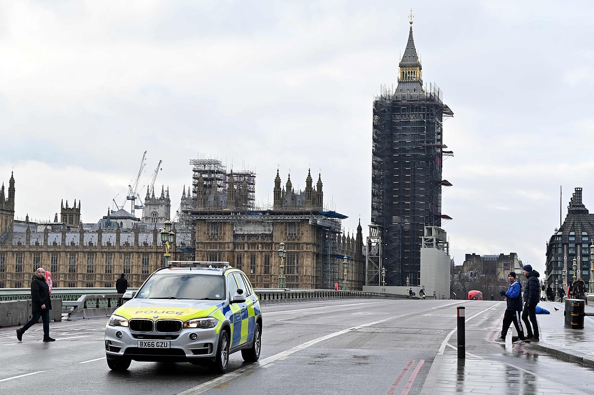A police vehicle patrols on a near-deserted Westminster Bridge in central London on 16 January 2021, during the third nationwide novel coronavirus COVID-19 lockdown