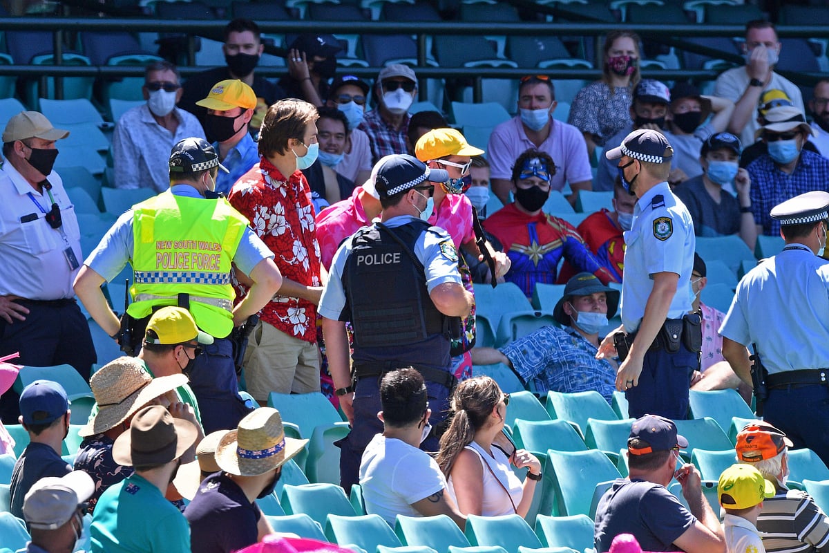 Policemen speak to the spectators as the game was halted after allegedly some remarks were made by the spectators on the fourth day of the third cricket Test match between Australia and India at the Sydney Cricket Ground (SCG) in Sydney on 10 January 2021