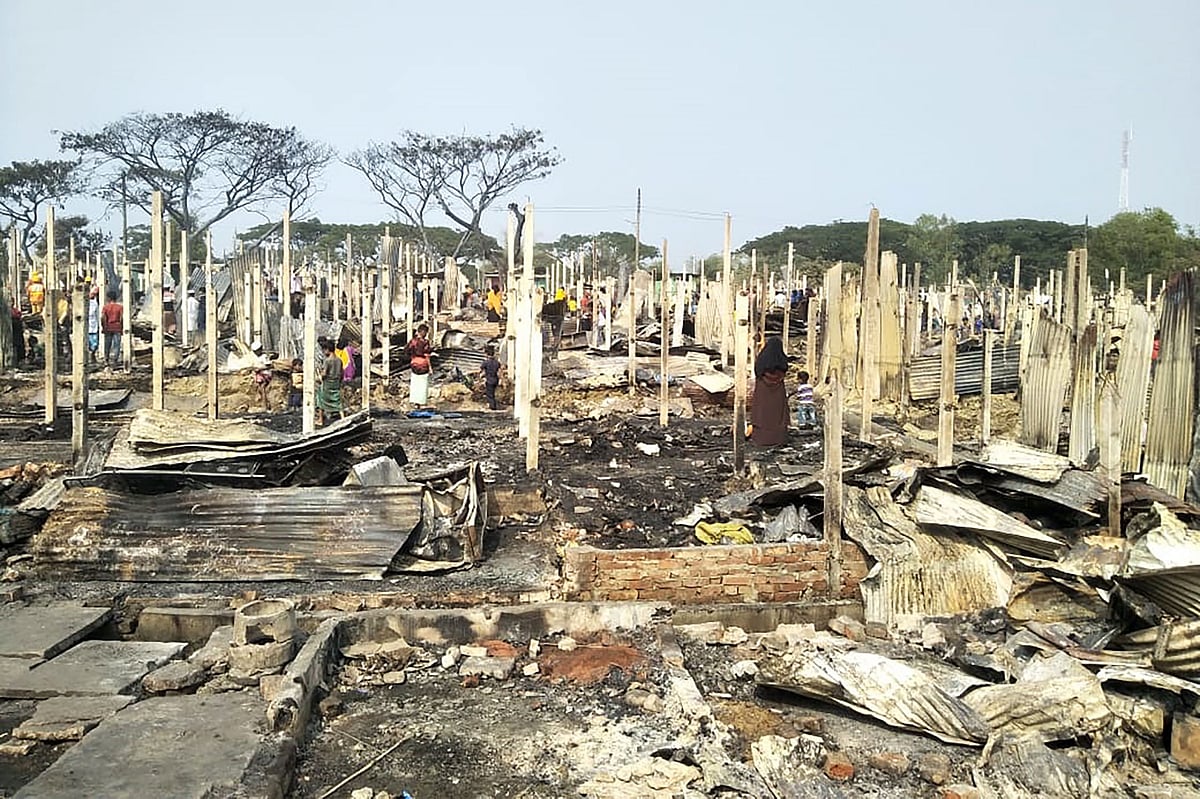 Rohingya refugees search for their belongings after a fire broke out at Nayapara refugee camp in Teknaf on 14 January 2021