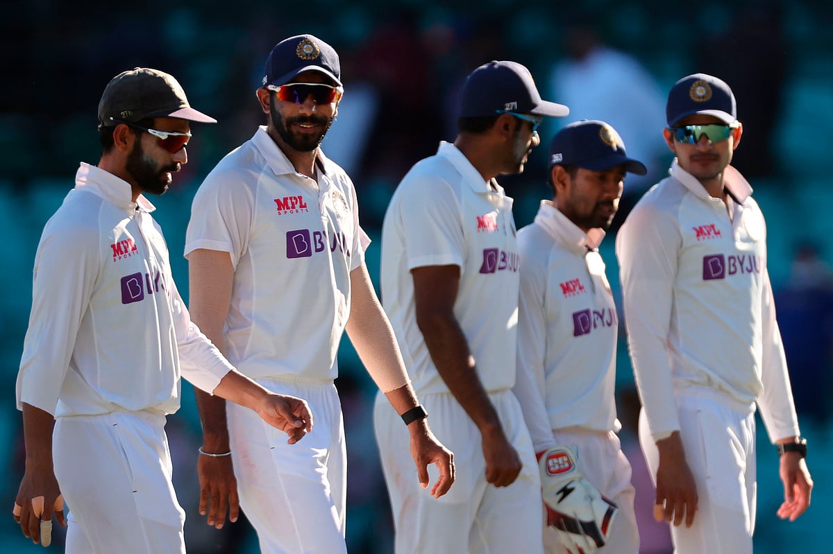 India's captain Ajinkya Rahane (L) walks along with his teammates at the end of the third day of the third cricket Test match between Australia and India at the Sydney Cricket Ground (SCG) in Sydney on 9 January , 2021