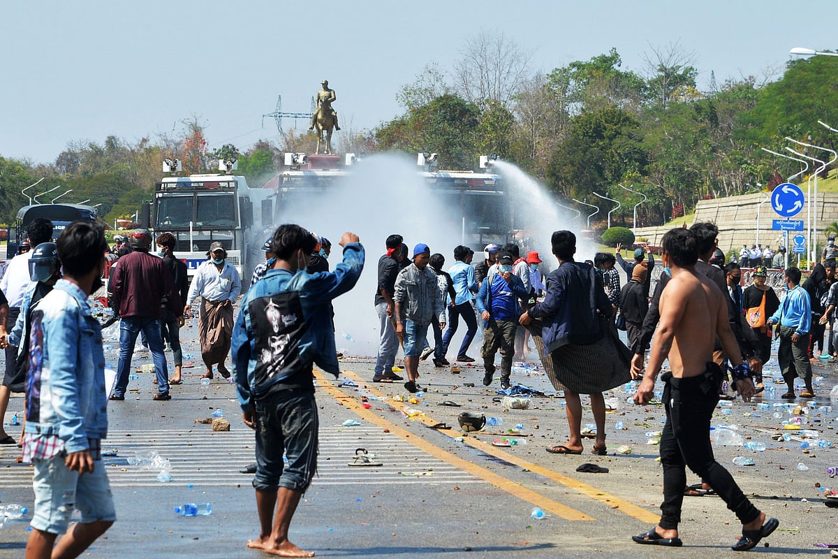 Police fire water cannons at protesters as they continue to demonstrate against the February 1 military coup in the capital Naypyidaw on 9 February 2021