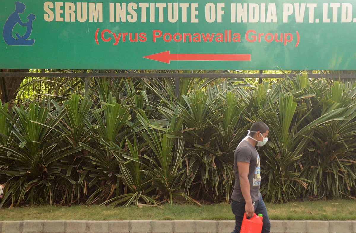 A man walks past a signpost of India's Serum Institute, the world's largest maker of vaccines, which is developing a vaccine against the coronavirus disease (COVID-19) at its laboratory in Pune, India, on 18 May 2020.