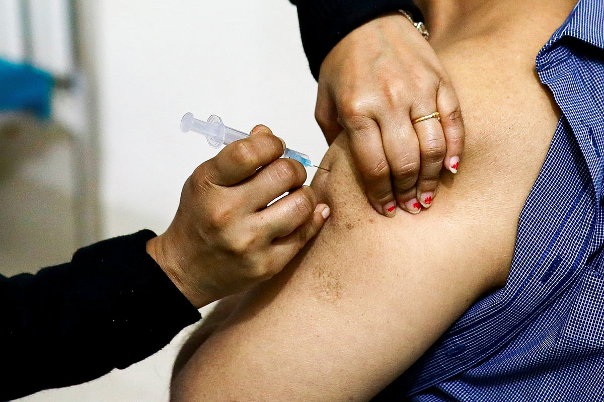A nurse injects the Oxford-AstraZeneca’s Covishield vaccine to a person at the Dhaka Medical College vaccination centre in Dhaka, Bangladesh, on 9 February 2021