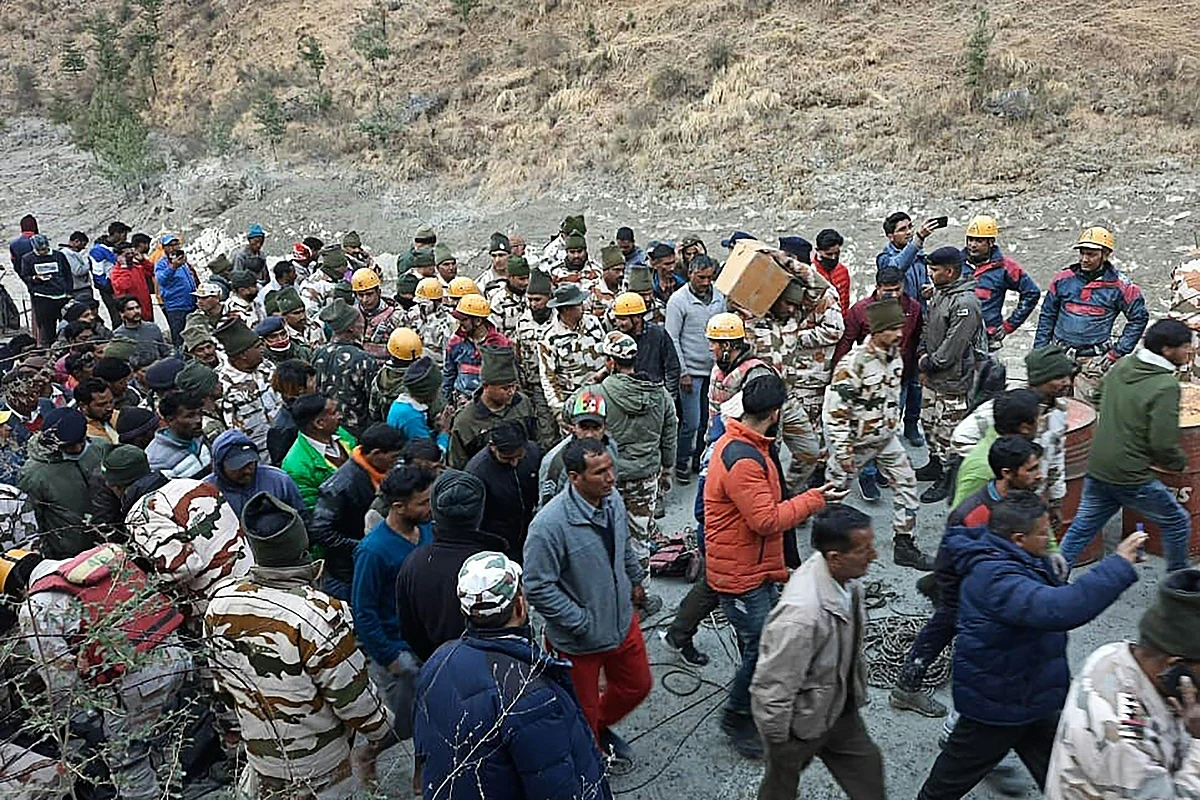 This handout photo taken on 7 February, 2021 and released by the Indo-Tibetan Border Police (ITBP) shows onlookers and members of the Indo-Tibetan Border Police (ITBP) during a rescue operation after a broken glacier caused a major river surge that swept away bridges and roads, at Reni village in Chamoli district of Uttarakhand