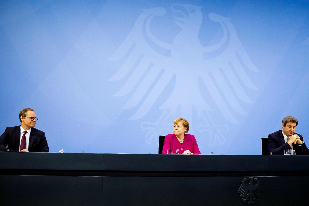 In this file photo taken on 4 March 2021 German Chancellor Angela Merkel (C), Bavarian state governor Markus Soeder (R) and the Mayor of Berlin Michael Mueller (L) deliver a press conference following talks via video conference with Germany's state premiers on the extension of the current Covid-19 restrictions, at the Chancellery in Berlin