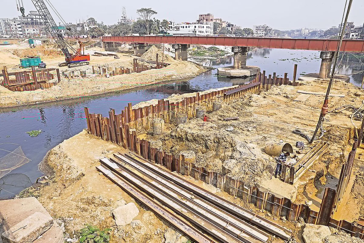 A new bridge being built beside an old one. The height of the bridge will not allow vessels to cross under  it during the rainy season. The photo was taken recently at the Turag river adjacent to Abdullahpur.