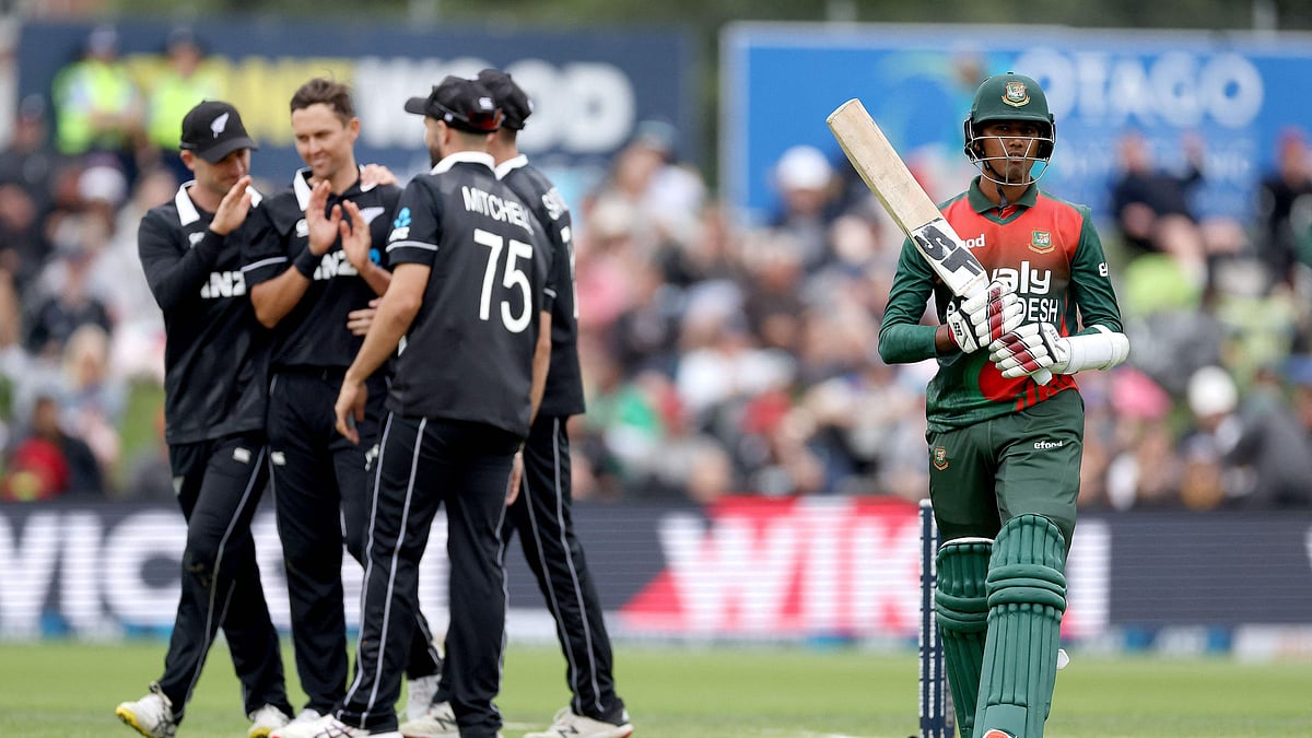 Bangladesh's Mehidy Hasan (R) walks from the field after being bowled as New Zealand players celebrate during the 1st cricket ODI match between New Zealand and Bangladesh at University Oval in Dunedin on 20 March 2021