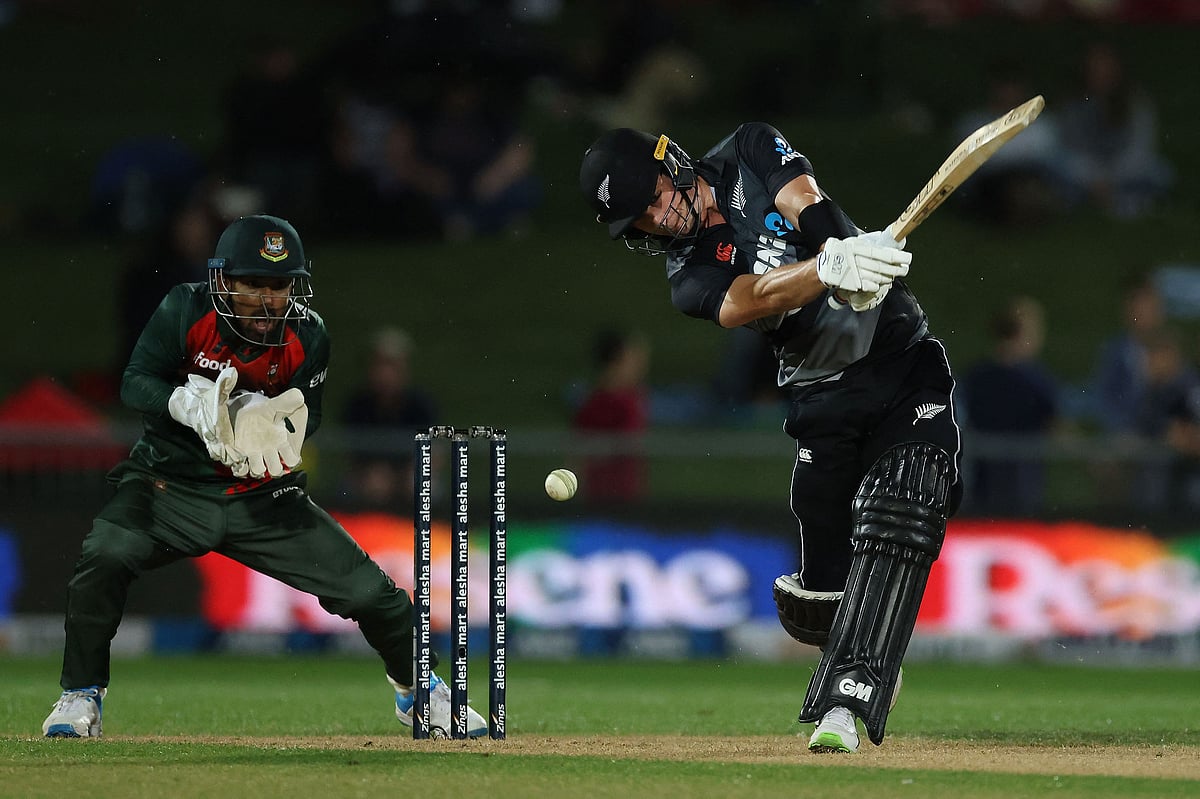 New Zealand's Will Young (R) plays a shot in front of Bangladesh's wicketkeeper Liton Das during the second Twenty20 cricket match between New Zealand and Bangladesh in Napier on 30 March 2021