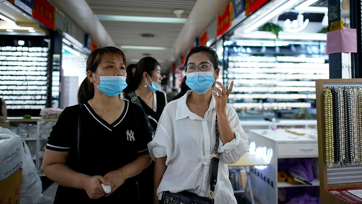 Women wearing face masks talk at the Yiwu Wholesale Market following an outbreak of the novel coronavirus disease (COVID-19), in Yiwu, Zhejiang province, China on 2 June 2020