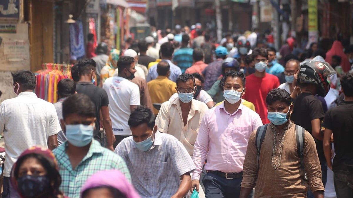 People throng to the market defying the health guidelines of weeklong lockdown imposed by government to curb the rising trend of Covid-19 infection. The picture was taken from Barobazar of Jashore.