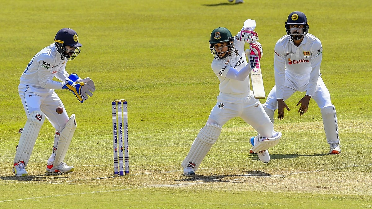 Bangladesh's Mushfiqur Rahim (C) plays a shot during the third day of the first Test cricket match between Sri Lanka and Bangladesh at the Pallekele International Cricket Stadium in Kandy on 23 April 2021