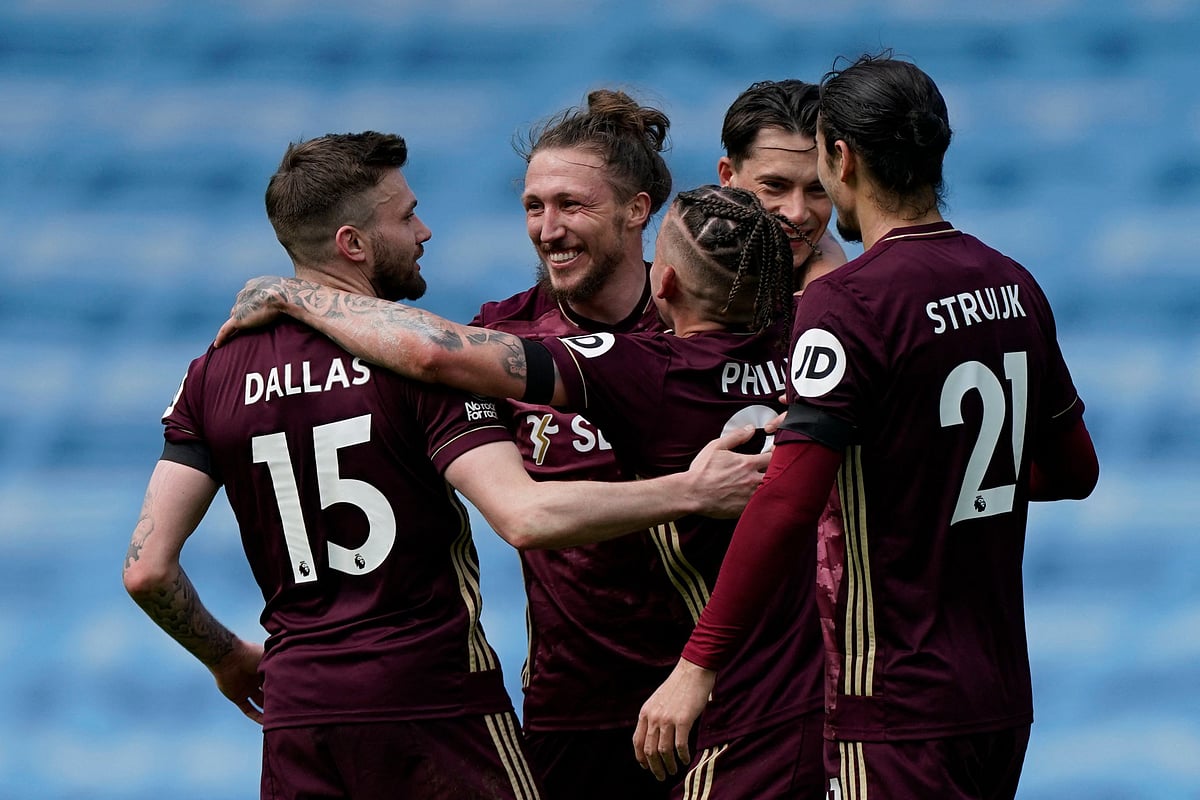 Leeds United's Northern Irish midfielder Stuart Dallas (L) celebrates with team mate at the end of the English Premier League football match between Manchester City and Leeds United at the Etihad Stadium in Manchester, north west England, on 10 April, 2021
