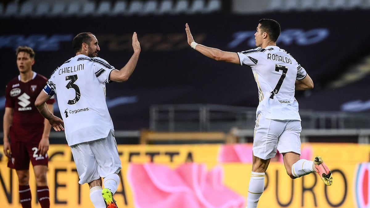 Juventus' Portuguese forward Cristiano Ronaldo (R) celebrates with Juventus' Italian defender Giorgio Chiellini after scoring an equaliser during the Italian Serie A football match Torino vs Juventus on 3 April 2021 at the Olympic stadium in Turin