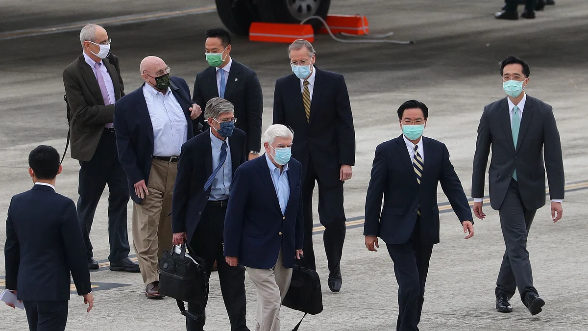 Former US Senator Chris Dodd, former US Deputy Secretary of State Jim Steinberg and former US Deputy Secretary of State Richard Armitage walk with Taiwan Foreign Minister Joseph Wu and American Institute in Taiwan (AIT) Director Brent Christensen as they arrive at Songshan airport in Taipei, Taiwan on 14 April 2021