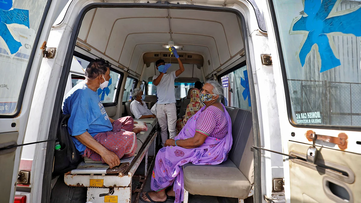 Patients are seen inside an ambulance while waiting to enter a Covid-19 hospital for treatment, amidst the spread of the coronavirus disease (Covid-19) in Ahmedabad, India, on 22 April 2021