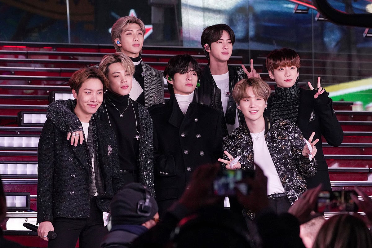 BTS members pose for a photograph