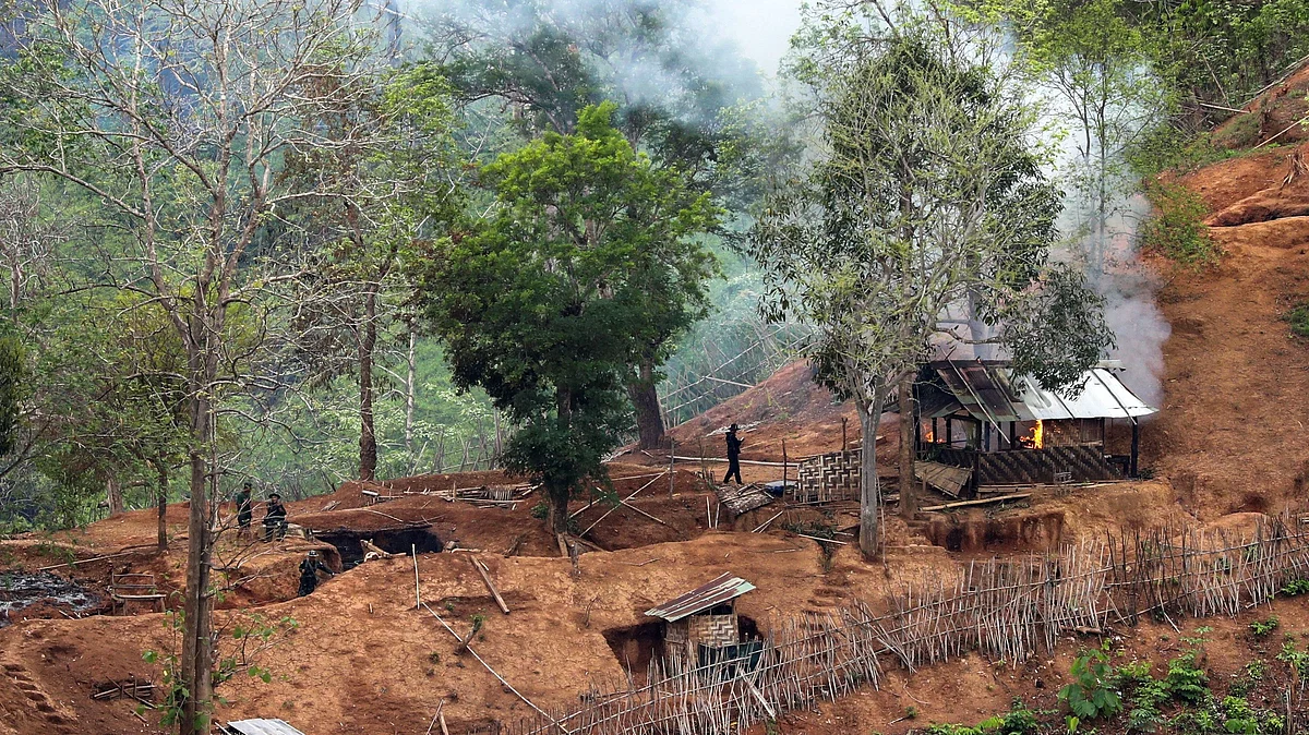 Ethnic minority Karen troops are seen after setting fire to a building inside a Myanmar army outpost near the Thai border, which is seen from the Thai side on the Thanlwin, also known as Salween, riverbank in Mae Hong Son province, Thailand, on 28 April 2021