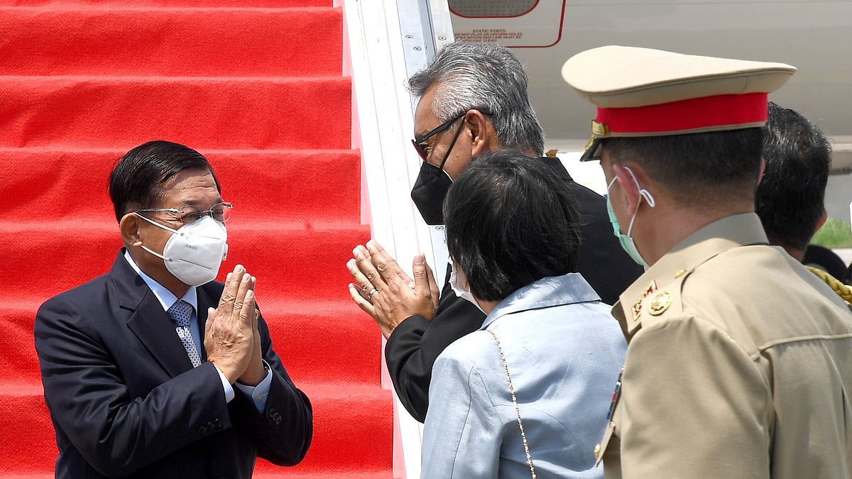Myanmar's junta chief Senior General Min Aung Hlaing (L) gestures as he is welcomed upon his arrival ahead of the ASEAN leaders' summit, at the Soekarno Hatta International airport in Tangerang, on the outskirts of Jakarta, Indonesia, on 24 April 2021