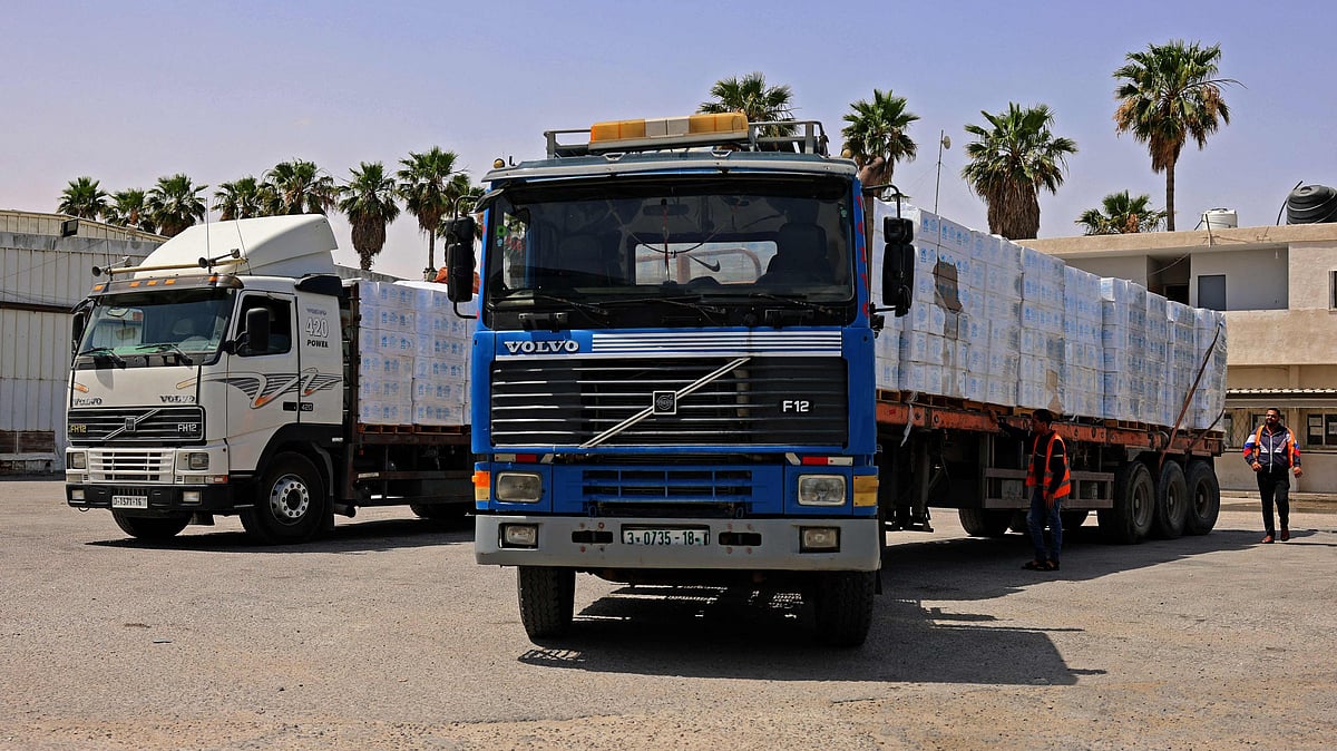 Trucks loaded with humanitarian aid, pass into Rafah in the southern Gaza Strip, through the Kerem Shalom crossing, the main passage point for goods entering Gaza from Israel, on 21 May 2021, after a ceasefire brokered by Egypt between Israel and the Palestinian Hamas movement.