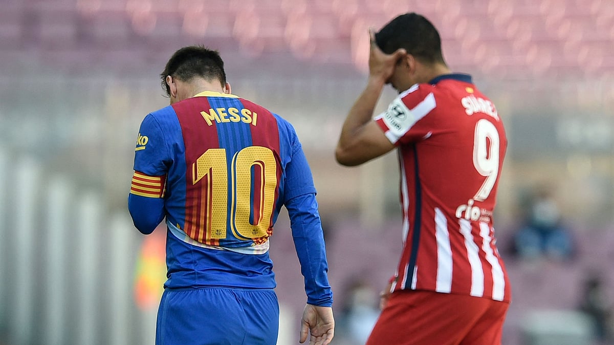 Barcelona's Argentinian forward Lionel Messi and Atletico Madrid's Uruguayan forward Luis Suarez leave the pitch during the Spanish league football match FC Barcelona against Club Atletico de Madrid at the Camp Nou stadium in Barcelona on 8 May 2021