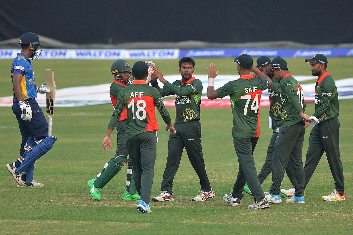 Bangladesh's players celebrate after the dismissal of Sri Lanka's Danushka Gunathilaka (L) during the first ODI cricket match between Bangladesh and Sri Lanka at the Sher-e-Bangla National Cricket Stadium in Dhaka on 23 May 2021