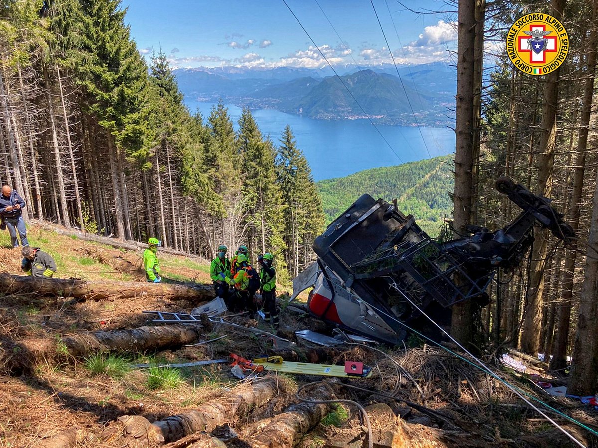 A photo taken and handout on 23 May by The Italian National Alpine and Speleological Rescue Corps (Corpo Nazionale Soccorso Alpino e Speleologico) shows a cable car that crashed to the ground in the resort town of Stresa on the shores of Lake Maggiore in the Piedmont region