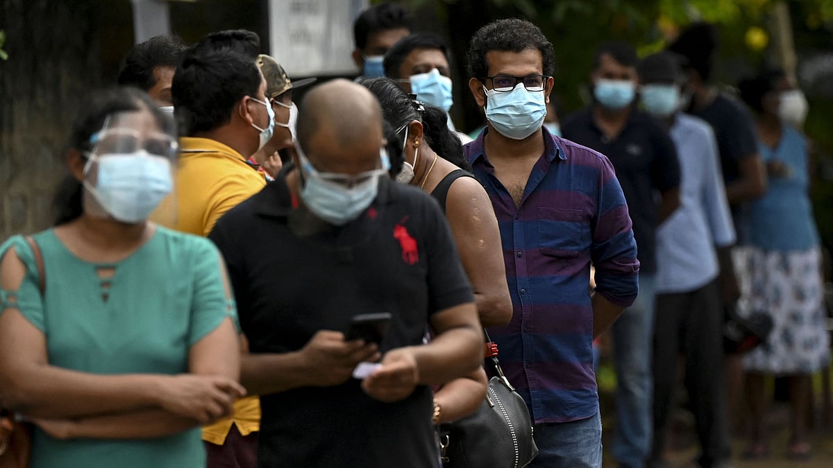 People stand in a queue as they wait to get a dose of the Chinese-made Sinopharm Covid-19 coronavirus vaccine in Panadura, a suburb of Sri Lanka's capital Colombo on 8 May 2021