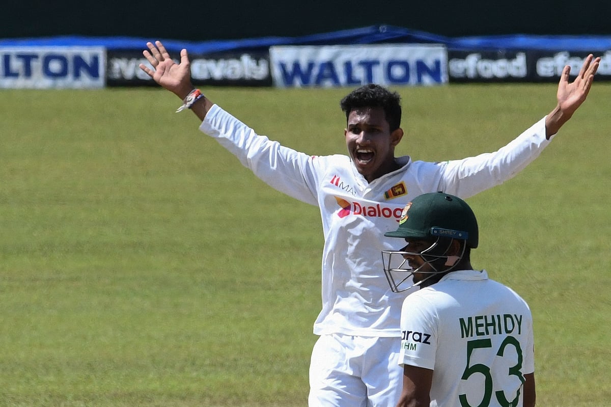 Sri Lanka's Praveen Jayawickrama celebrates after he dismissed Bangladesh's Liton Das (C) during the final day of the second and final Test cricket match between Sri Lanka and Bangladesh at the Pallekele International Cricket Stadium in Kandy on 3 May, 2021