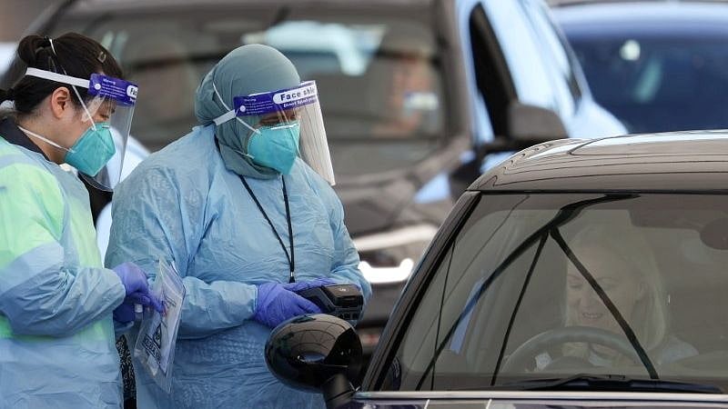 Medical workers administer tests at the Bondi Beach drive-through coronavirus disease (Covid-19) testing centre in the wake of new positive cases in Sydney, Australia on 17 June 2021.