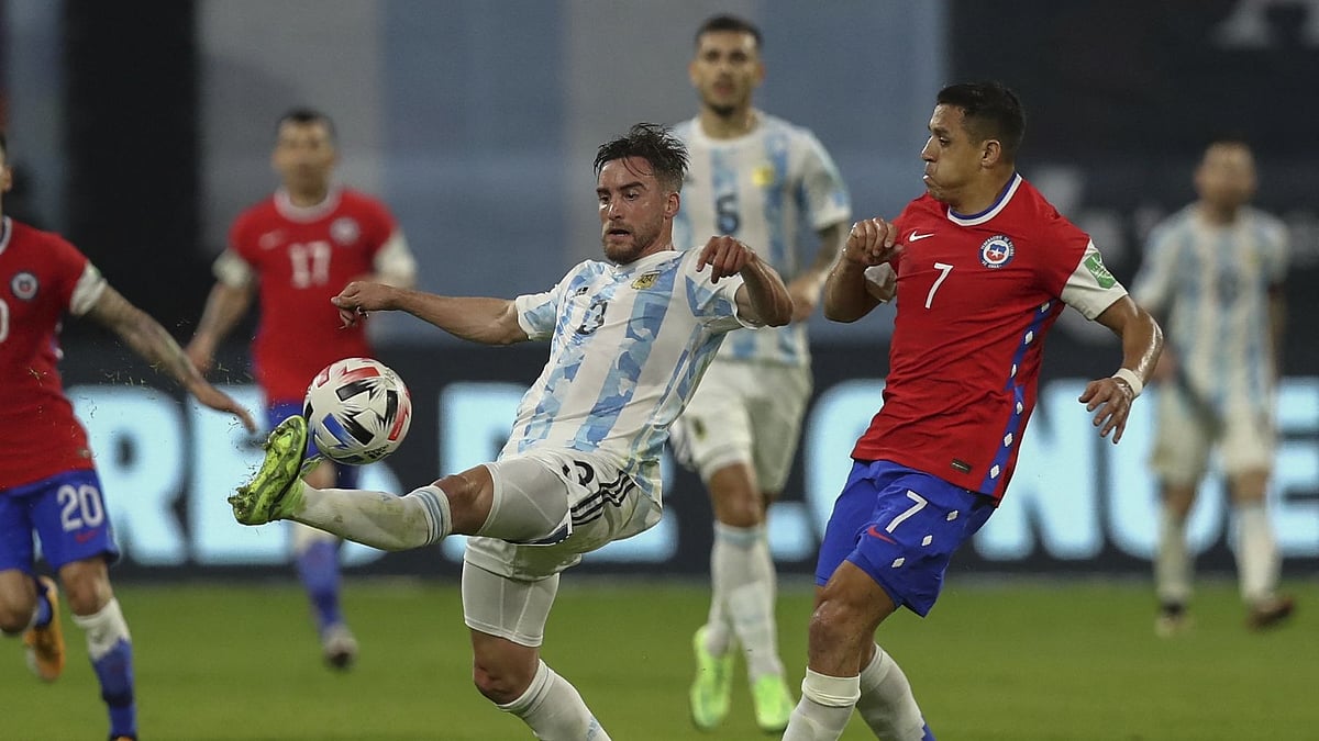 Argentina's Nicolas Tagliafico (L) controls the ball next to Chile's Alexis Sanchez during their South American qualification football match for the FIFA World Cup Qatar 2022 at the Estadio Unico Madre de Ciudades stadium in Santiago del Estero, Argentina, on 3 June 2021