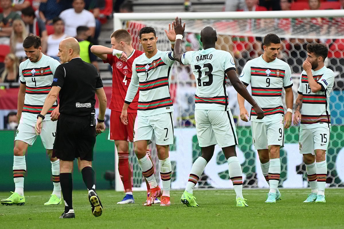 Portugal's forward Cristiano Ronaldo (CL) celebrates with Portugal's midfielder Danilo Pereira their first goal scored by Portugal's defender Raphael Guerreiro during the UEFA EURO 2020 Group F football match between Hungary and Portugal at the Puskas Arena in Budapest on 15 June, 2021