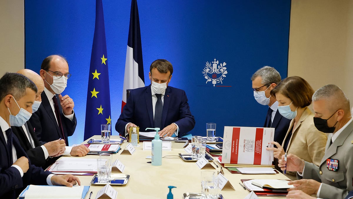 French president Emmanuel Macron and French prime minister Jean Castex (3L) at the national security meeting to discuss Pegasus spyware in the Jupiter room at The Elysee Presidential Palace in Paris, on 22 July, 2021