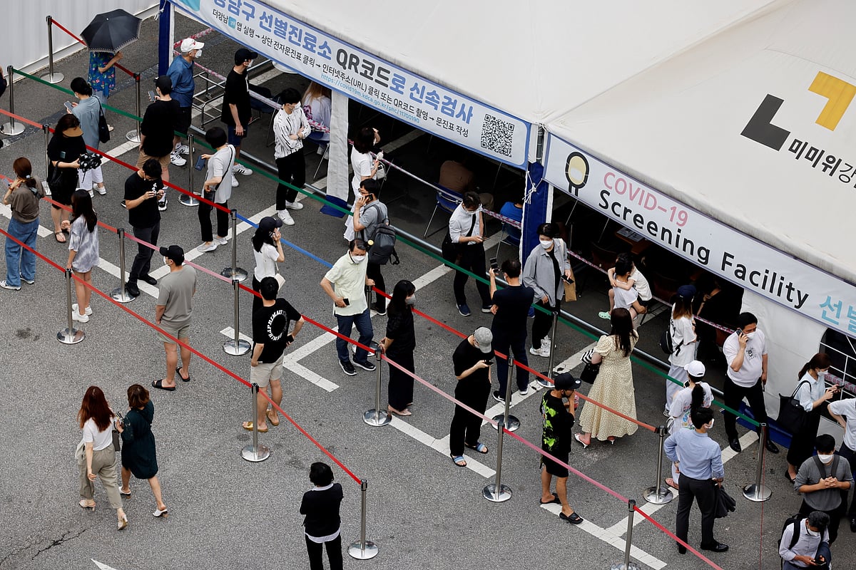 People wait in line for a coronavirus disease (Covid-19) test at a testing site which is temporarily set up at a public health center in Seoul, South Korea, 9 July 2021.
